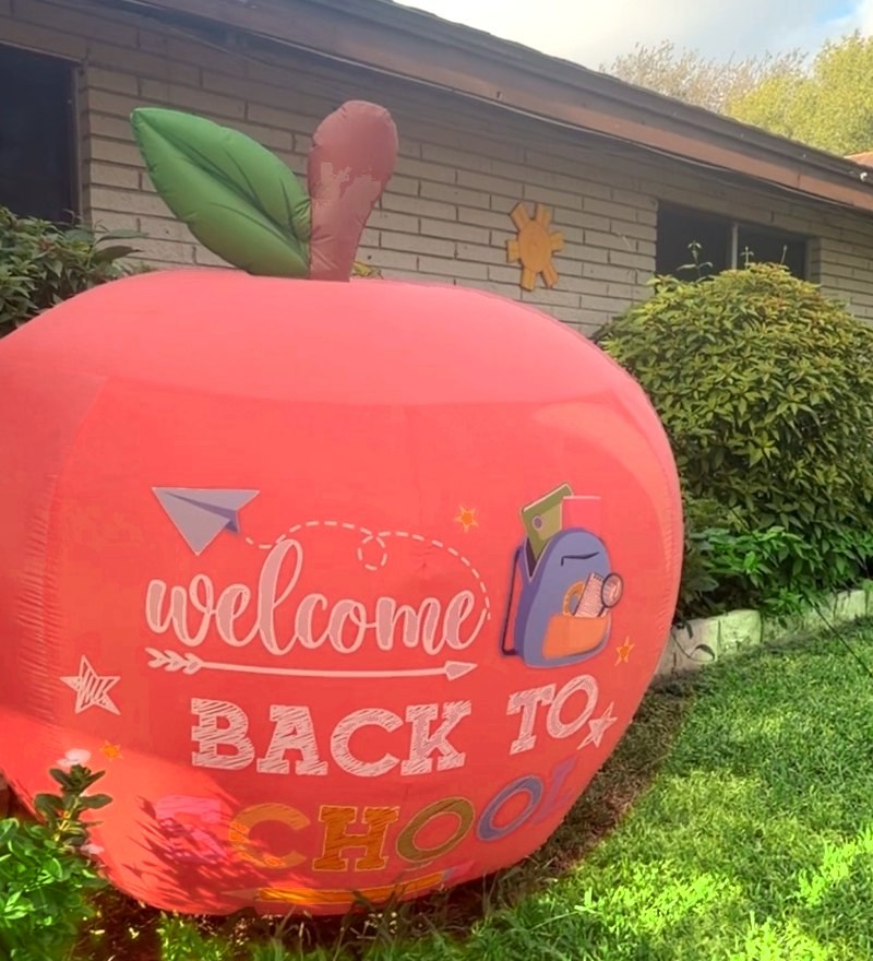 The front of Nookino Learning Center in Edinburg with a giant apple welcoming children